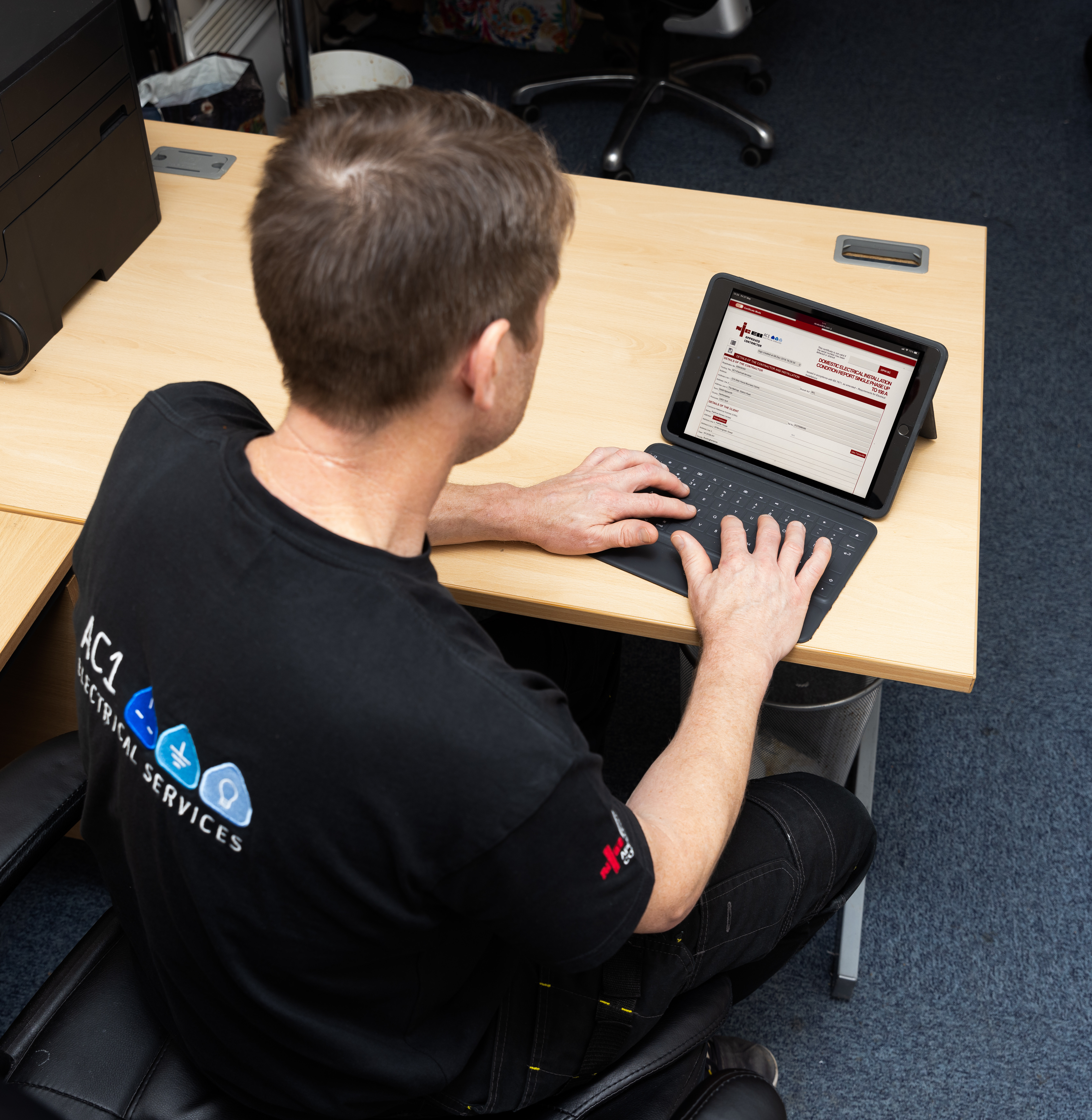AC1 Electrical team member preparing an invoice or quotation for an installation project.